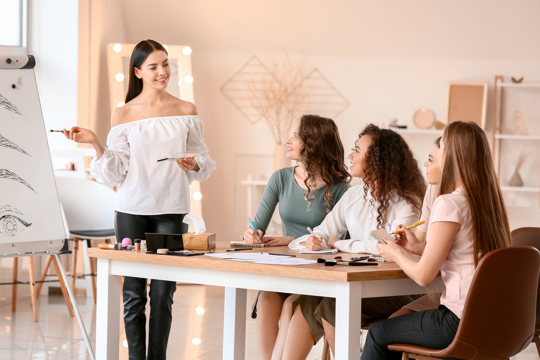 Young Woman Teaching Students in Makeup School